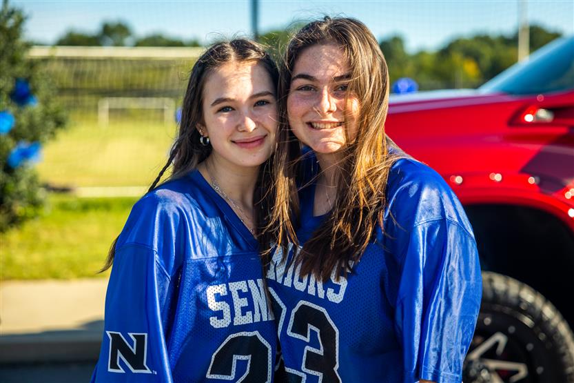 Two students smile